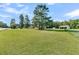 Spacious lot with a home and outbuildings visible in the distance at 1144 Old Mill Rd, Saint Stephen, SC 29479