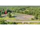 Aerial view showing home location, land, and wooded surroundings at 1144 Old Mill Rd, Saint Stephen, SC 29479