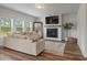 Light-filled living room featuring a fireplace and large windows at 4413 Palm Shadow Dr, Summerville, SC 29485