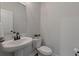 Small powder room with pedestal sink and white toilet at 4413 Palm Shadow Dr, Summerville, SC 29485