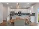 Modern kitchen with white cabinets and a round dining table at 4413 Palm Shadow Dr, Summerville, SC 29485