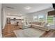 Open living room with kitchen views and a comfy sectional sofa at 4413 Palm Shadow Dr, Summerville, SC 29485
