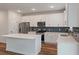 Modern kitchen with white cabinets and blue tile backsplash at 4413 Palm Shadow Dr, Summerville, SC 29485