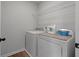 Convenient laundry room with washer, dryer, and shelving at 4413 Palm Shadow Dr, Summerville, SC 29485
