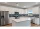 Modern kitchen with white cabinets and an island at 4413 Palm Shadow Dr, Summerville, SC 29485