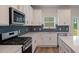 Modern kitchen features stainless steel appliances and blue geometric backsplash at 4413 Palm Shadow Dr, Summerville, SC 29485
