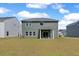 Green lawn and covered patio in the backyard at 4413 Palm Shadow Dr, Summerville, SC 29485