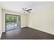 Bedroom with dark wood floors and sliding glass door to balcony at 2317 Tall Sail Dr # 1007 G, Charleston, SC 29414