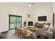 Living room with fireplace, wood floors, and access to screened porch at 2317 Tall Sail Dr # 1007 G, Charleston, SC 29414