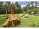 Large backyard with fire pit, picnic table, and plenty of green space at 111 Beam St, Huger, SC 29450