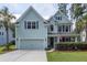 Two-story house with light blue siding, gray shutters, and a two-car garage at 111 Beam St, Huger, SC 29450