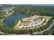 Aerial view of community with clubhouse, pool, and lake at 1103 Summerwind Ln, Seabrook Island, SC 29455