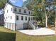 Two story home with white siding, gray garage, and a landscaped yard at 1203 Cecil Cir, Charleston, SC 29412