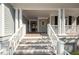 Charming front porch with white columns and wooden steps at 3064 Marshgate Dr, Seabrook Island, SC 29455