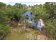 Luxury home showcasing a charming light blue exterior, deck, and lush landscaping at 3064 Marshgate Dr, Seabrook Island, SC 29455