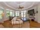 Sunroom features hardwood floors, a striped couch, and access to a deck at 3064 Marshgate Dr, Seabrook Island, SC 29455