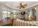 Sunroom with hardwood floors, striped couch, and views of backyard at 3064 Marshgate Dr, Seabrook Island, SC 29455
