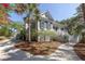 Charming two-story home with a wraparound porch and landscaped yard at 3064 Marshgate Dr, Seabrook Island, SC 29455
