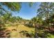 Landscaped backyard with palm trees and marsh view at 3064 Marshgate Dr, Seabrook Island, SC 29455