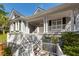 Elevated home with white columns and a welcoming front porch at 3064 Marshgate Dr, Seabrook Island, SC 29455