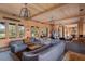 Open living space featuring wood-paneled walls and multiple seating areas at 6024 Selkirk Plantation Rd, Wadmalaw Island, SC 29487