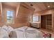 Charming bedroom with wood walls, a large window, and built-in shelving at 6024 Selkirk Plantation Rd, Wadmalaw Island, SC 29487