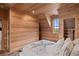 Bright bedroom with wood walls and a window overlooking marsh views at 6024 Selkirk Plantation Rd, Wadmalaw Island, SC 29487