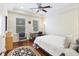 Bright bedroom with hardwood floors, built-in desk, and ceiling fan at 291 Coming St, Charleston, SC 29403