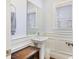 Small bathroom with pedestal sink and wainscoting at 291 Coming St, Charleston, SC 29403