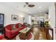 Living room with hardwood floors, red couch, and open concept kitchen at 291 Coming St, Charleston, SC 29403