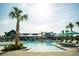 Large pool with lounge chairs, umbrellas, and a clubhouse in the background at 400 Swaying Pine Ln, Summerville, SC 29486