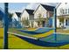 Community lawn with blue hammocks and charming homes in background at 400 Swaying Pine Ln, Summerville, SC 29486