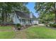 Light blue house with a white porch, two-car garage, and landscaped yard at 137 Fox Chase Dr, Goose Creek, SC 29445