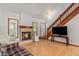 Cozy living room features a fireplace, hardwood floors, and a staircase leading to the upper level at 137 Fox Chase Dr, Goose Creek, SC 29445