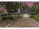 Light blue house with a white porch, two-car garage, and landscaped yard at 137 Fox Chase Dr, Goose Creek, SC 29445