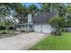 Light blue house with a white porch, two-car garage, and landscaped yard at 137 Fox Chase Dr, Goose Creek, SC 29445