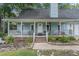 Light blue house with a white porch, two-car garage, and landscaped yard at 137 Fox Chase Dr, Goose Creek, SC 29445