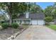 Light blue house with a white porch, two-car garage, and landscaped yard at 137 Fox Chase Dr, Goose Creek, SC 29445