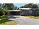 Home features a carport for covered parking and a spacious driveway at 110 Groves St, Walterboro, SC 29488