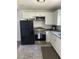 Modern kitchen with white shaker cabinets, stainless steel appliances, and granite countertops at 110 Groves St, Walterboro, SC 29488