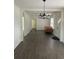 Bright dining room with dark gray vinyl plank flooring and chandelier at 110 Groves St, Walterboro, SC 29488