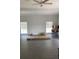 Spacious living room with ceiling fan, large windows, and vinyl flooring at 110 Groves St, Walterboro, SC 29488