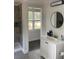 Updated bathroom with white vanity, tile floors, and a walk-in shower at 110 Groves St, Walterboro, SC 29488