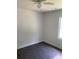 Bright bedroom with ceiling fan and dark gray vinyl flooring at 110 Groves St, Walterboro, SC 29488