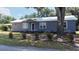 Charming bungalow with a metal roof, purple exterior, and well-manicured landscaping at 110 Groves St, Walterboro, SC 29488
