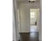 Clean hallway with vinyl plank flooring and access to bathroom at 110 Groves St, Walterboro, SC 29488
