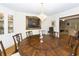 Formal dining room with large round table and crystal chandelier at 103 President Cir, Summerville, SC 29483