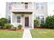 House exterior featuring a front porch, American flag, and well-maintained landscaping at 131 Tin Can Aly, Summerville, SC 29483