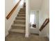 Carpeted staircase with wooden handrail and window seat at 131 Tin Can Aly, Summerville, SC 29483