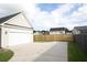 Attached garage with a spacious driveway and wooden fence at 131 Tin Can Aly, Summerville, SC 29483